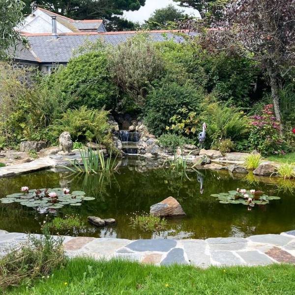 Spacious wooden deck patio with outdoor seating and small table in garden